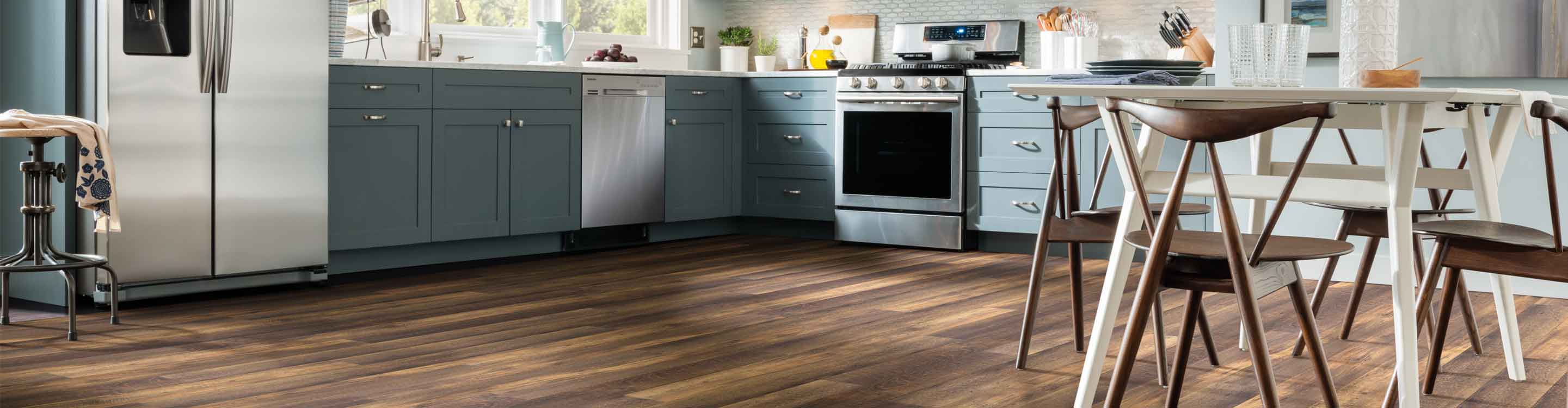 Luxury vinyl plank flooring in a modern kitchen and dining space