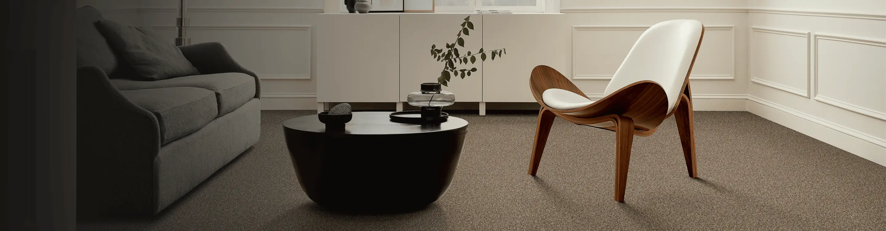Living room with brown carpet and wooden accent chair