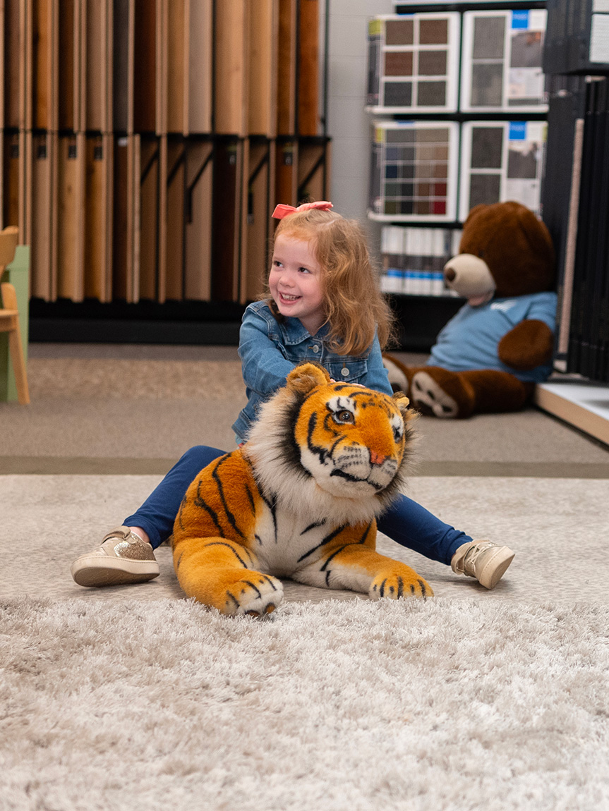 kids playing on newly installed Carpet One vinyl flooring in playroom